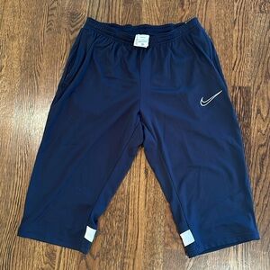 Men’s Nike large 3/4 pants Navy Blue with white strip on back.